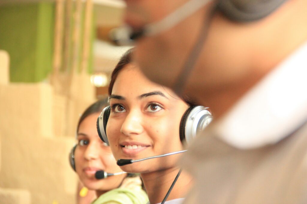 People working in customer service center with head sets on.
