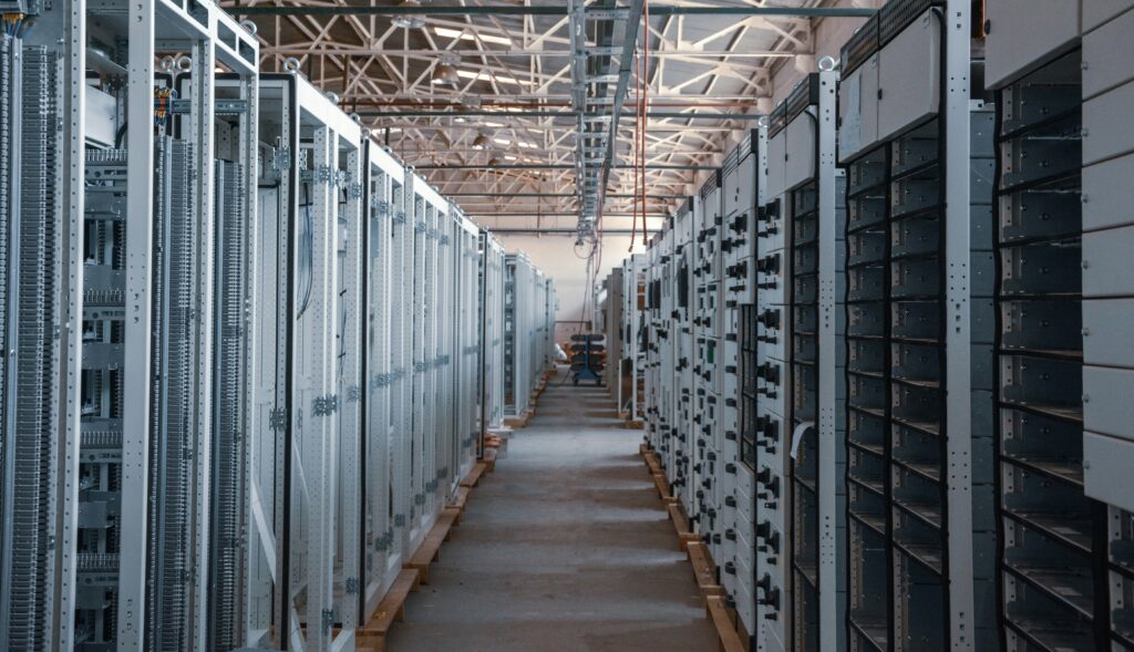 Data center with rows of stainless steel racks.