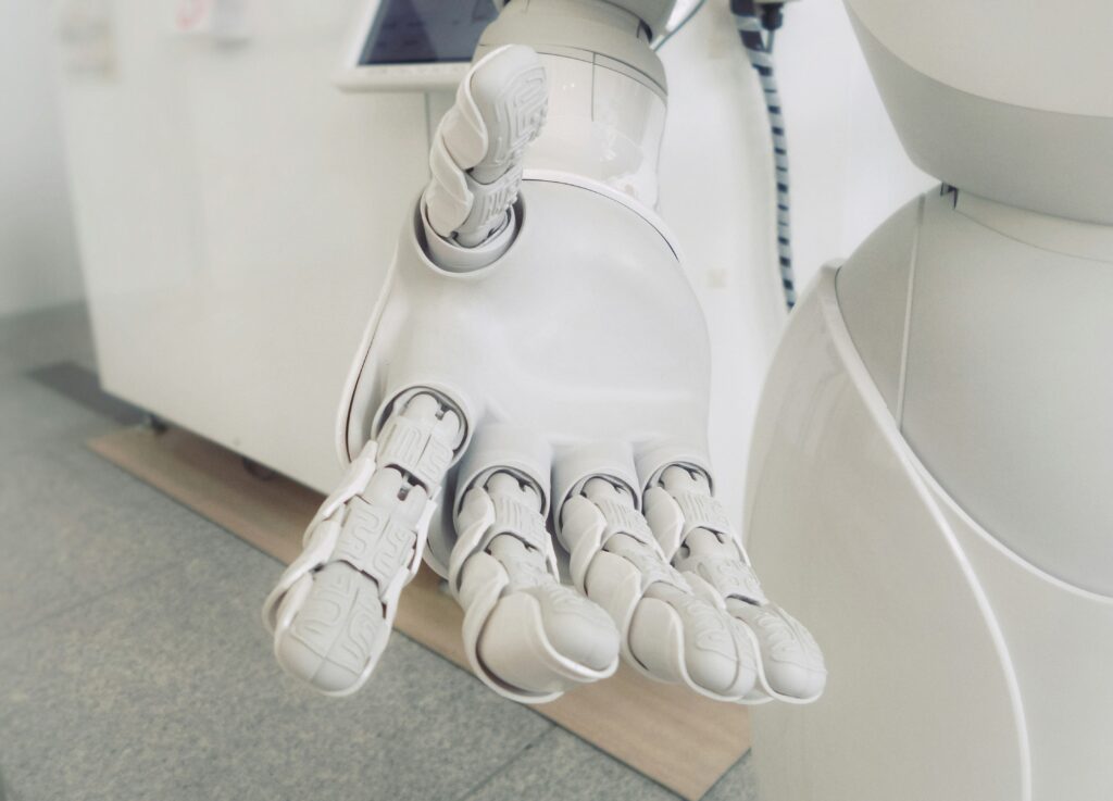 White robot hand reaching out